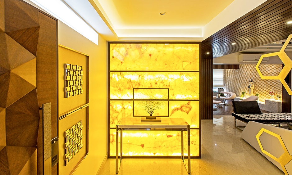 Contemporary entryway table with warm lighting and 3D wall decor