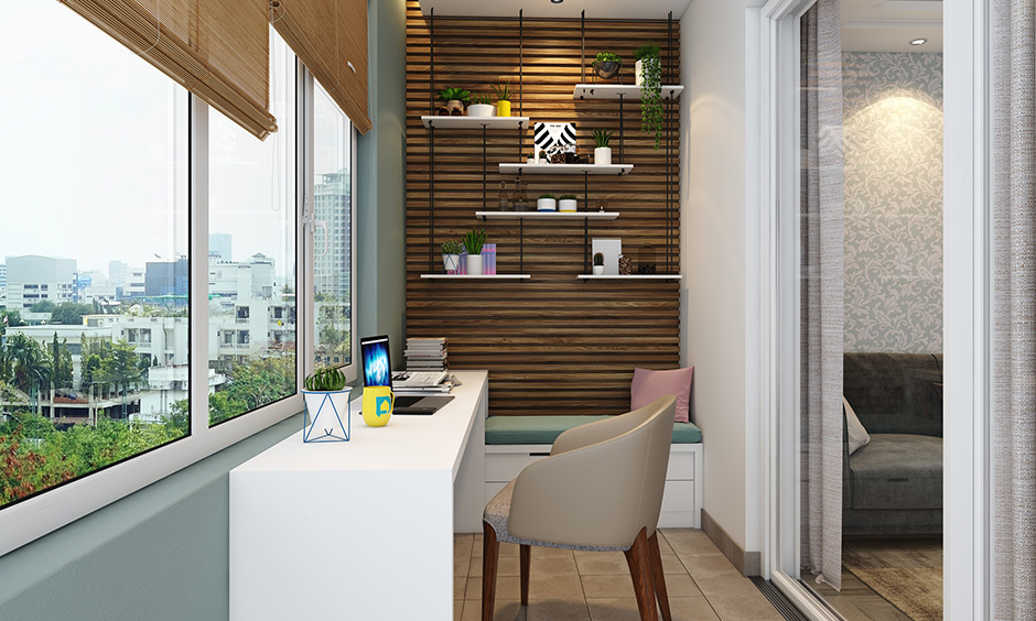 A home office setup with sunroom design with large glass windows