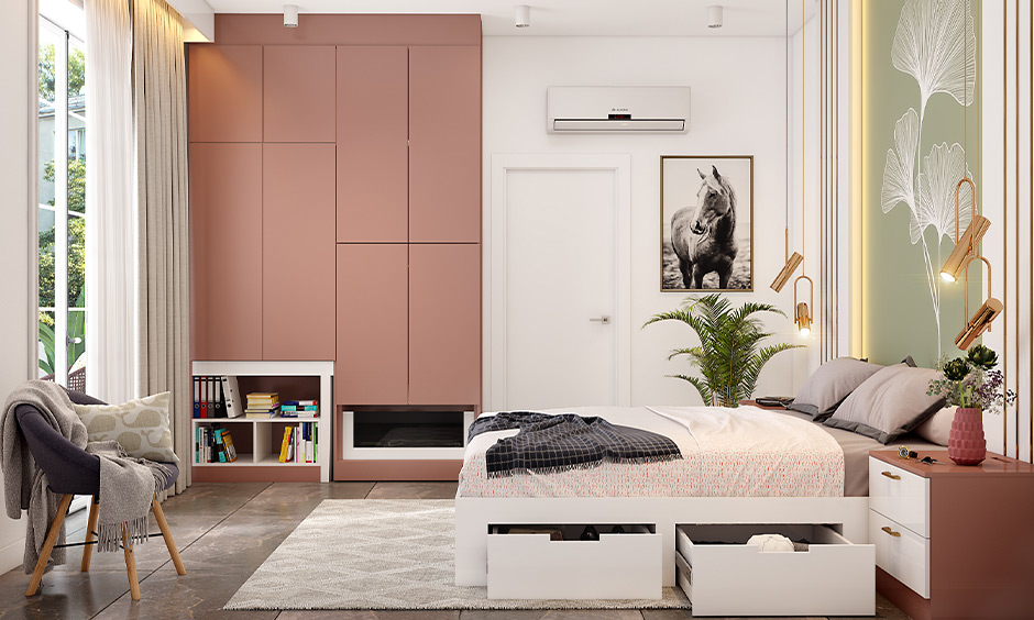 Wall-embedded almirah design with dusty pink asymmetric partitions maximizes floor space