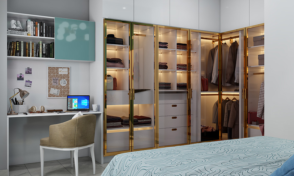 L-shaped wall-fixed almirah in white with glass doors offers a posh and elegant look