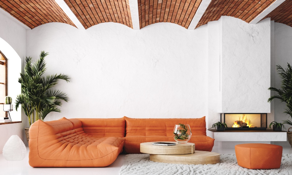 Curved gypsum ceiling design with wooden boards in between creates a creatively balanced look in the room