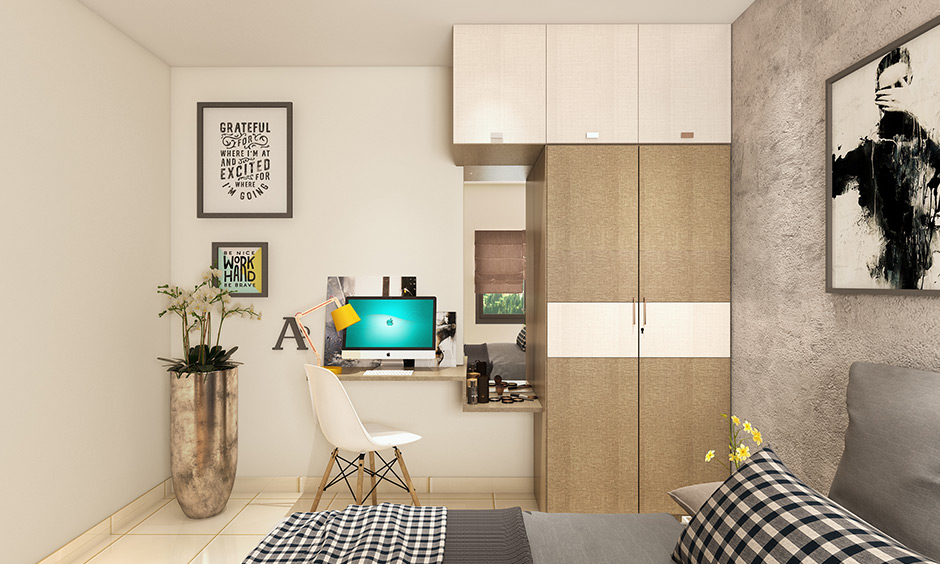 Minimalistic bedroom with cosy style includes a space-saving wardrobe that extends as a dresser and study table