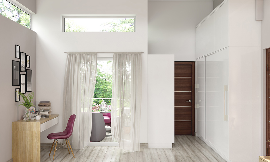 White minimalist bedroom interior design features flowy white curtains strewn across the adjoining balcony