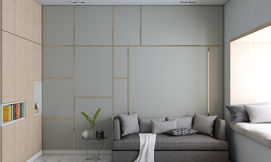 Light grey living room has a spacious bay window seat and modern gold-accented walls