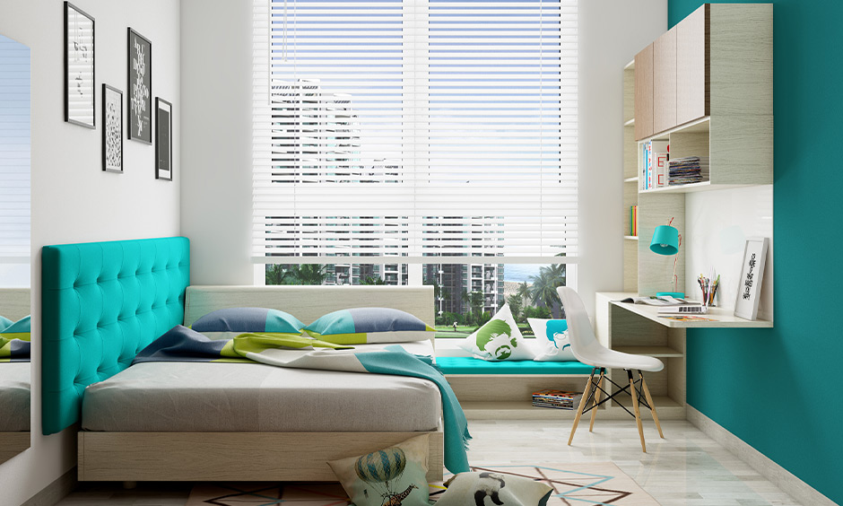 Bay window seat with storage slots in a light blue and white themed bedroom