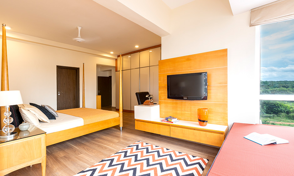 White bedroom with wall-mounted tv unit is perfect for cosy movie nights