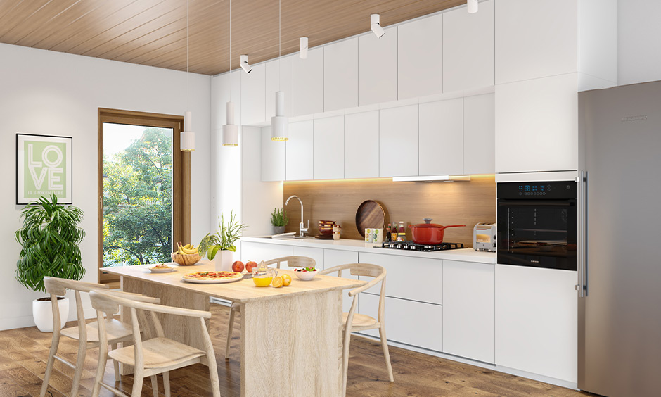 Make a small dark kitchen look bigger by installing a large window to brighten the area