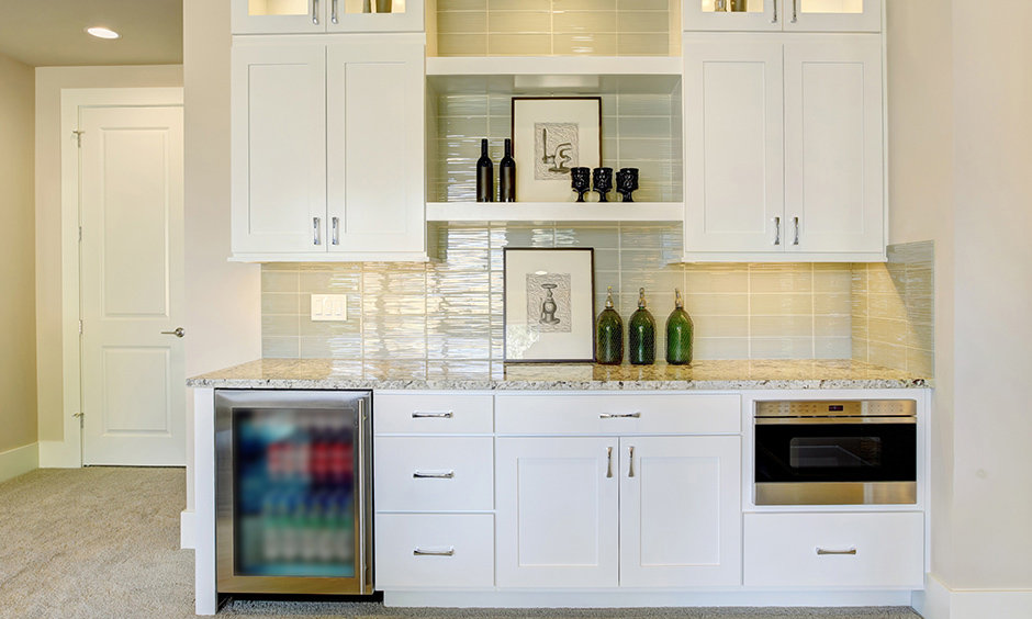 Small home bar cabinet design with refrigerator lending a minimalistic touch