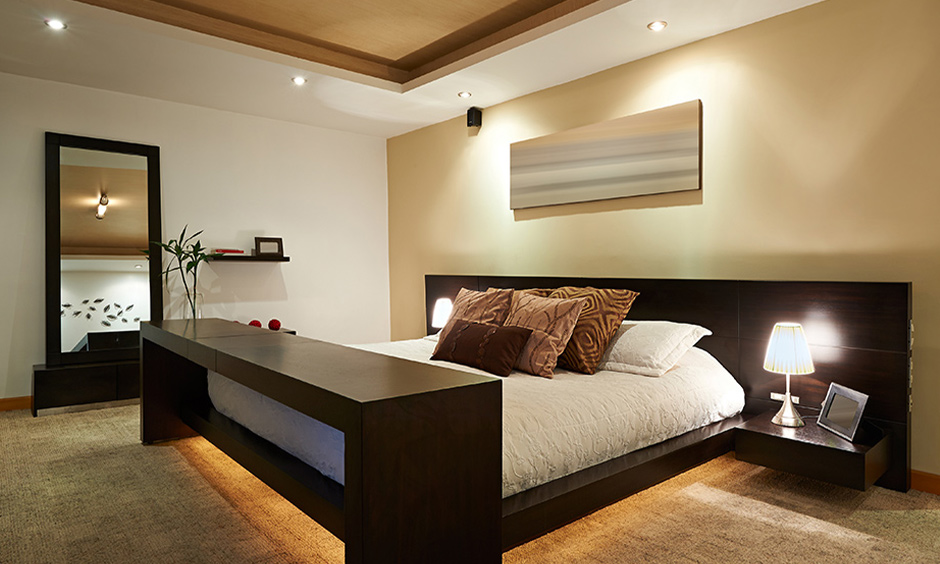South Indian interior style bedroom with an elevated false ceiling