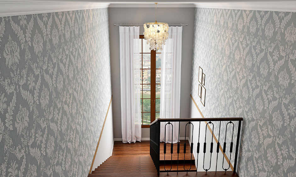 Staircase landing window design with sheer white curtains draped over it cast a soothing ambience