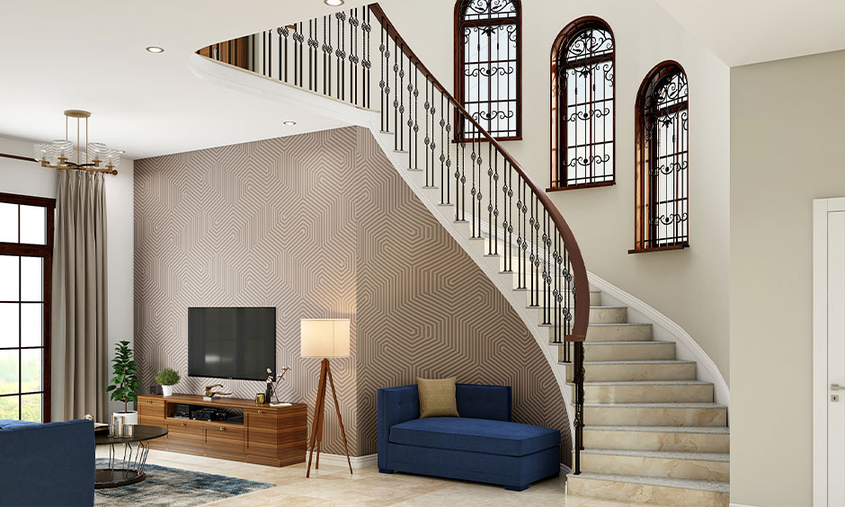 Stunning curved staircase with intricate grill-designed windows, playing with light and shadow