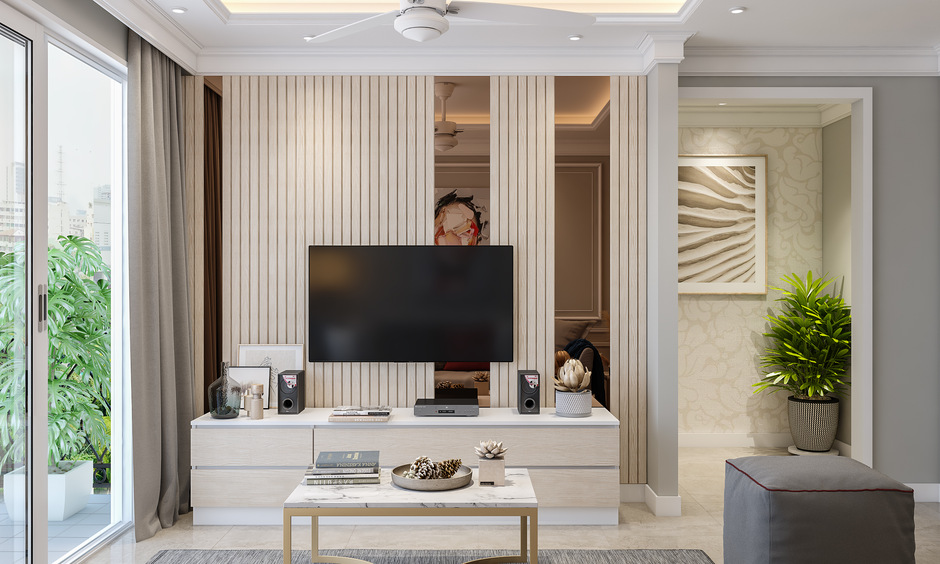 Bronze mirror wall panel behind the TV elevate the living room