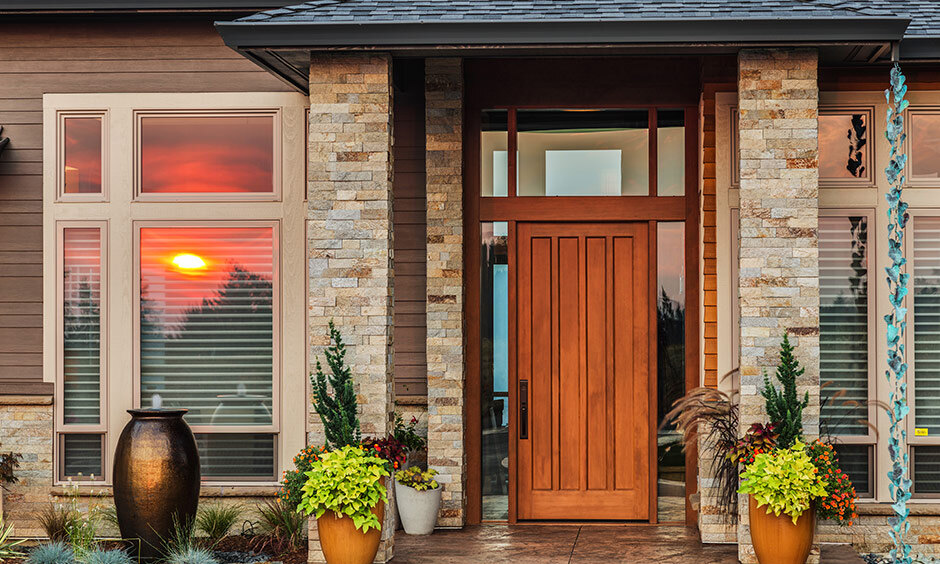 Main door design made of glass and amber wood