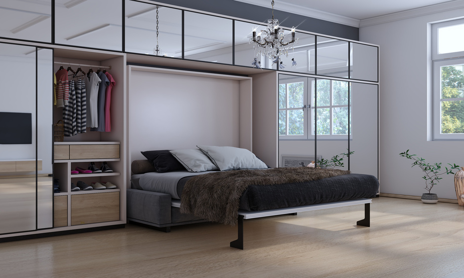 Studio apartment with full-length mirror panelling on the wall creates serene space
