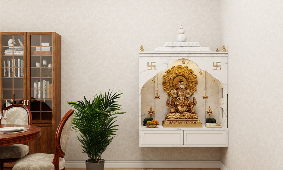 Small pooja unit in living room crafted from white marble and wall-mounted