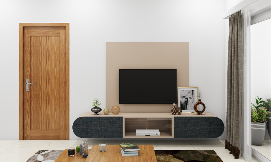 Contemporary console table with a beige top and a black rounded silhouette storage