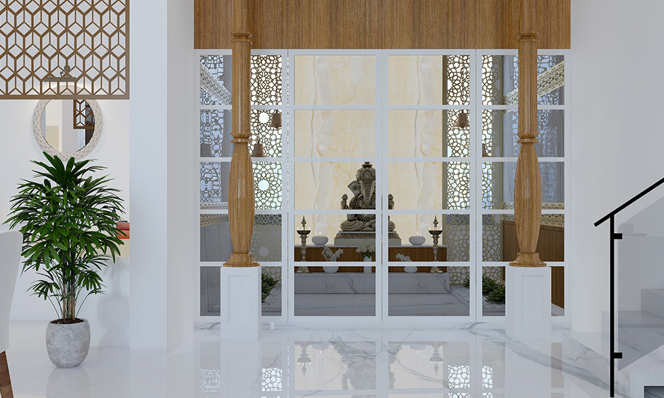 Pooja room design in dining hall incorporates tinted glass