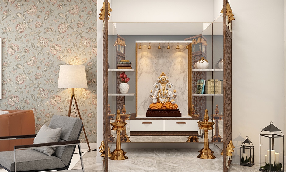 Wall-mounted pooja shelf design that is space-saving and has a glass backdrop wall