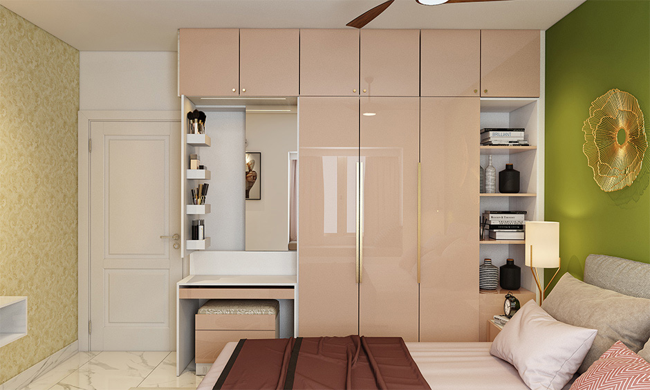 Pink laminated wardrobe attached dressing table with storage behind the mirror