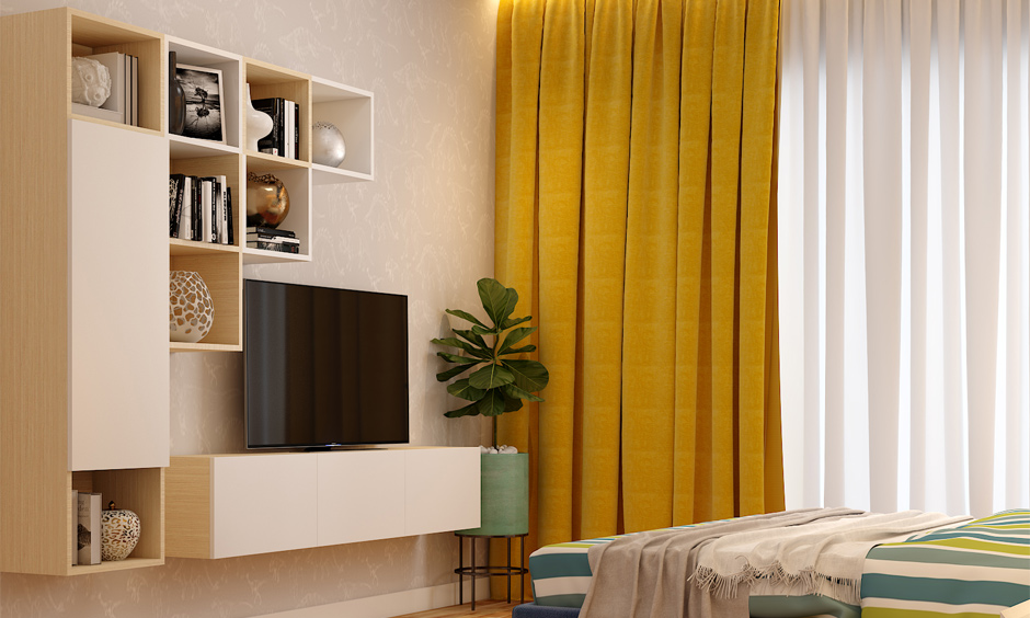 Cosy bedroom features a low-corner TV unit and an attached open-box storage shelf