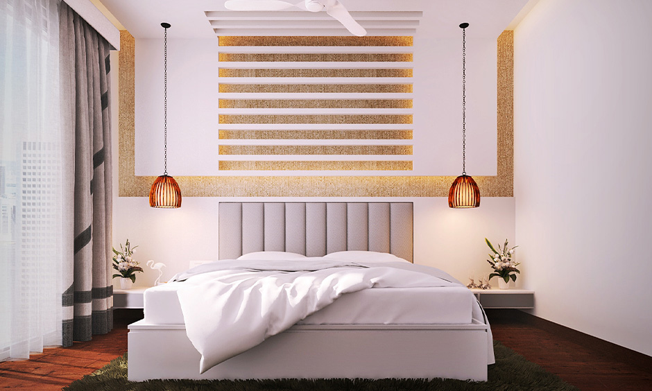 Minimalistic aesthetic bedroom with a white bedspread and pendant lights on the bedside