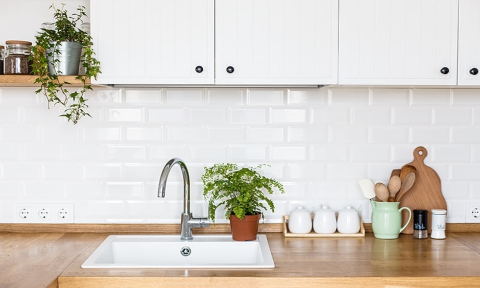 Simple modern kitchen sink designed in minimalism and sits on top of a counter