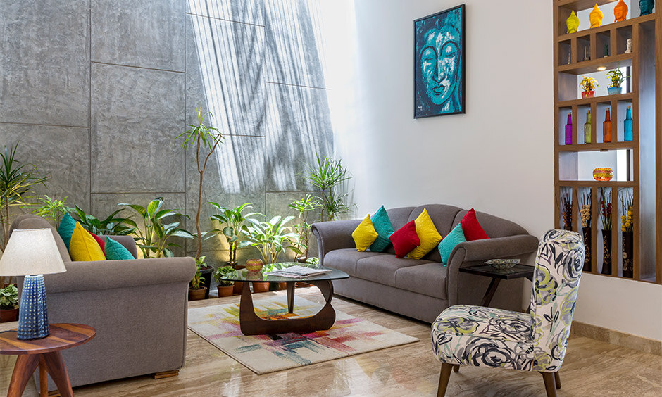 Biophilic interior design in the living room features stone-textured tiles as a backdrop