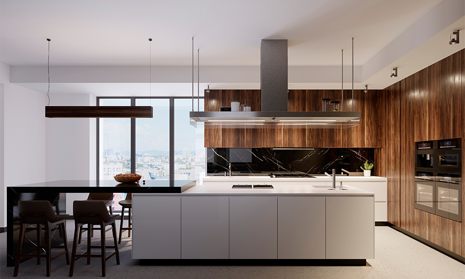 Spacious luxury kitchen interior with a large island, high-end quartz countertops, and stylish under-island lighting.