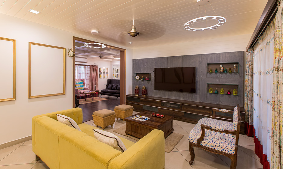 Sagwan wood sofa in the living room furnished with plush cushions to provide ultimate relaxation