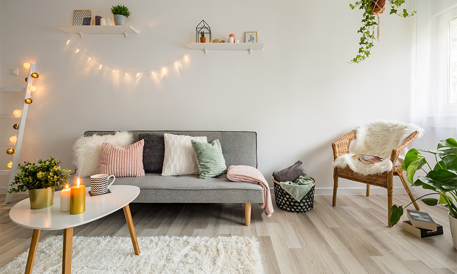 Beige wooden floor tiles coupled with rattan furniture for a cosy vibe