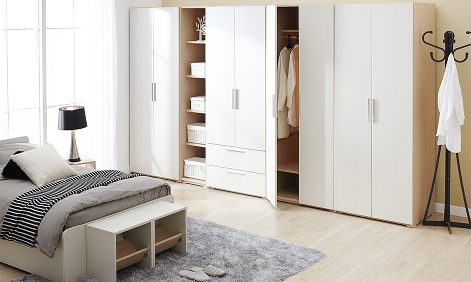 Bedroom with a wooden bench table features indoor shoe storage