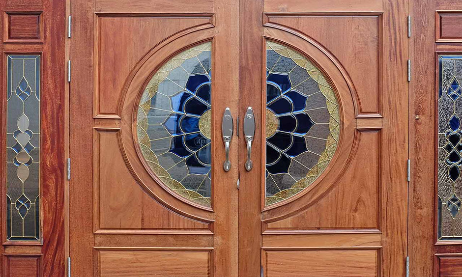 Intricately carved double-door wood design for the main door