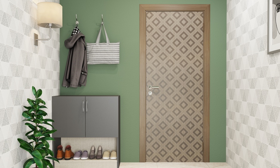 A flush door with a diamond geometry tiled sunmica pattern elevates the entryway of a modest home