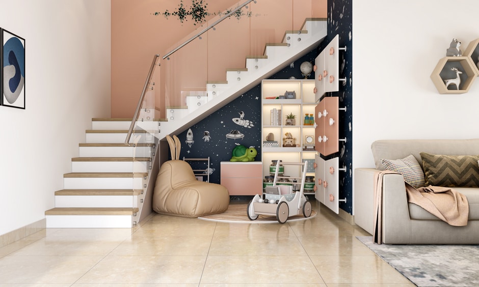 A modern glass stair railing with a play area underneath creates a functional and stylish space