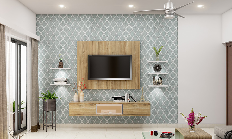 Simple TV wall paint design showcasing a light grey accent, complemented by natural wood tones and lush greenery