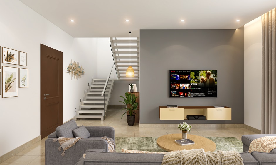 A stair steel railing design with glass enhances the open living room, offering elegance and airy views