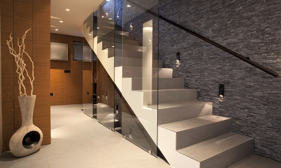 Stair side wall tile design with handrail placed on the wall