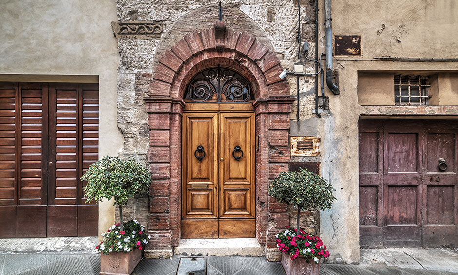 Vintage double-door wood carvings reflect the grandeur of a bygone era, serving as a majestic main entrance
