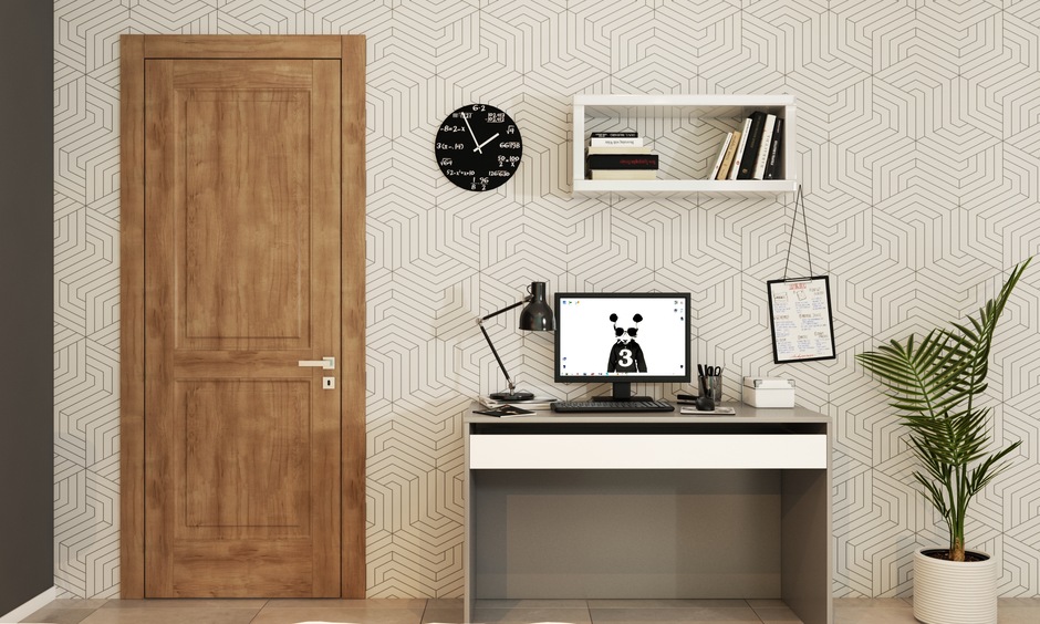 A wood flush door with mica accents serves as a stunning focal point in a minimalist, monochromatic interior design