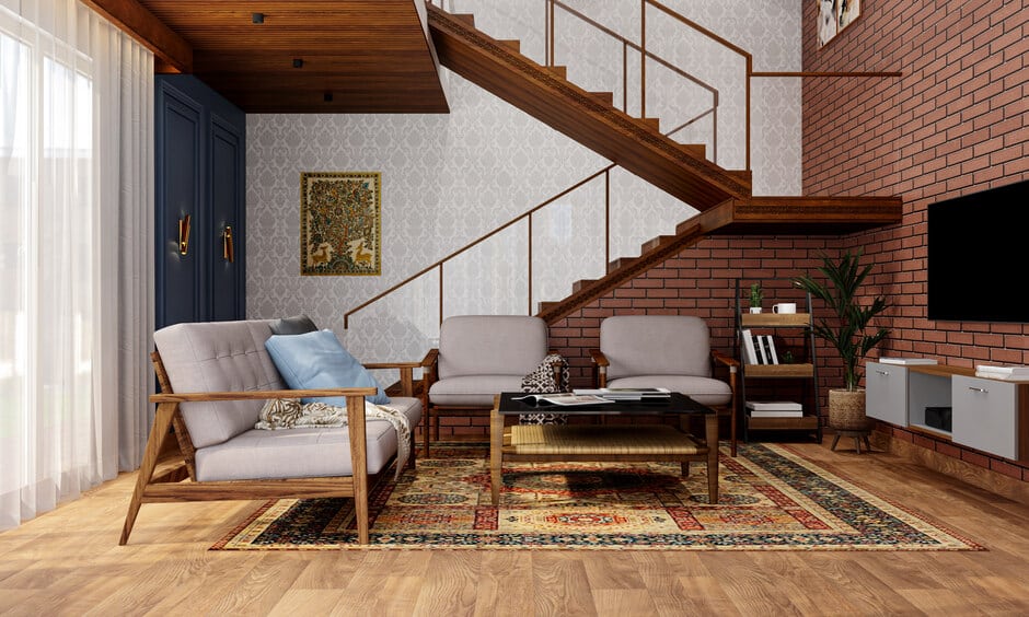 A stylish living room showcasing a wooden stair railing with glass, complemented by a plush couch for seating