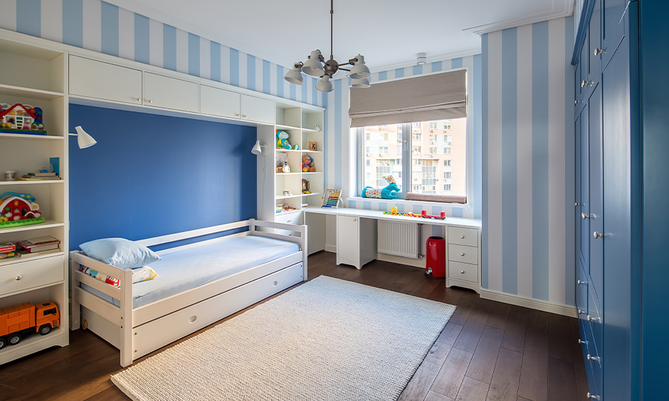 Whimsical striped walls, plush cushions, and playful toys transform a child's bedroom into a creative oasis