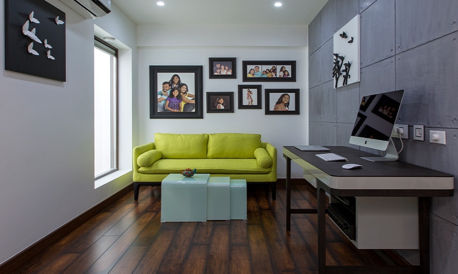 Study-leisure room with dark brown PVC carpet, white-grey walls, and a bright yellow sofa