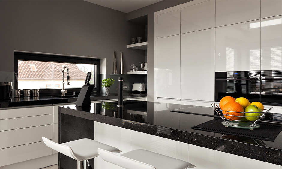 A modern black granite kitchen island with a luxurious appearance