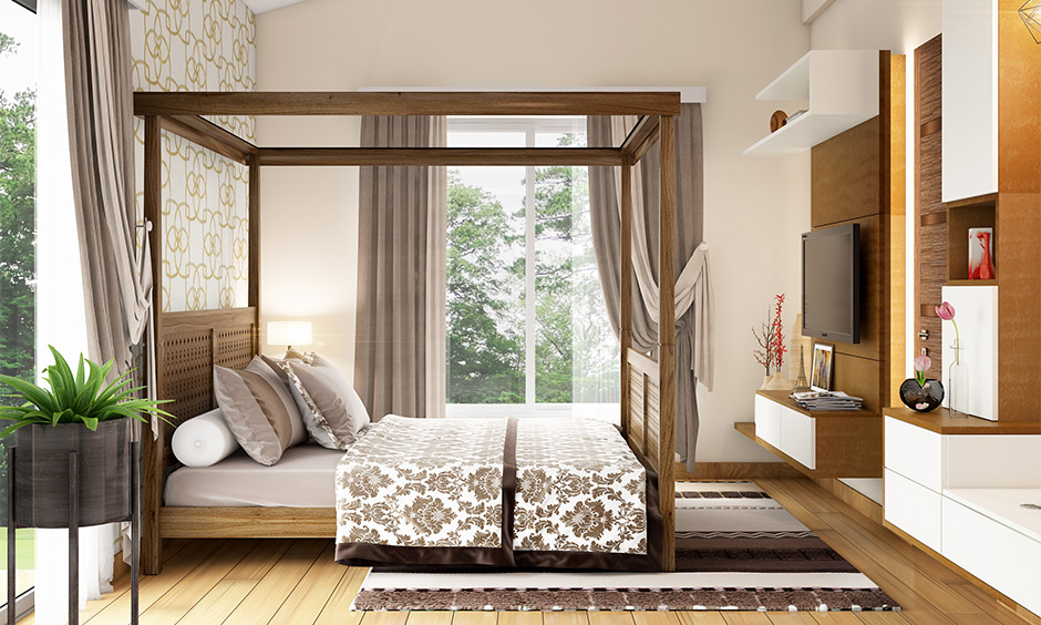 A beautifully restored wooden bed frame adds charm and warmth to a cosy, renovated old bedroom