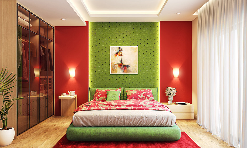 Red and green colour combination: A bedroom adorned with red walls and a green headboard