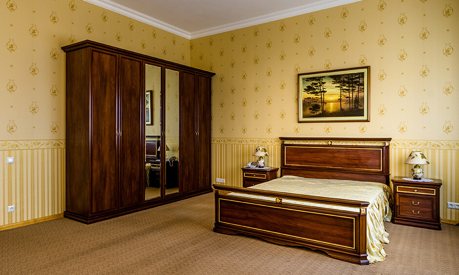 Cosy bedroom with dark golden walls complementing brown and beige tones.