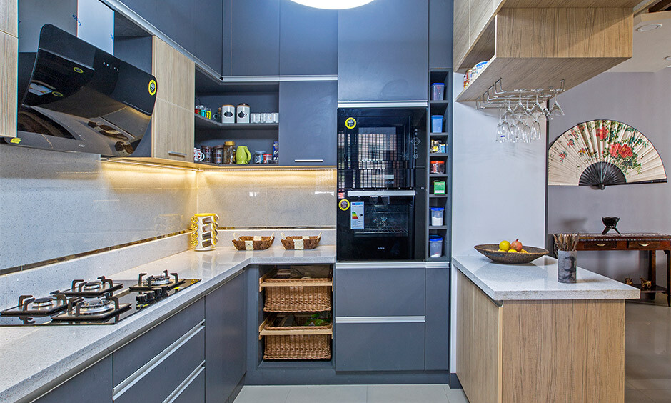 Blue and white modular kitchen with glossy wall tiles and cabinetry