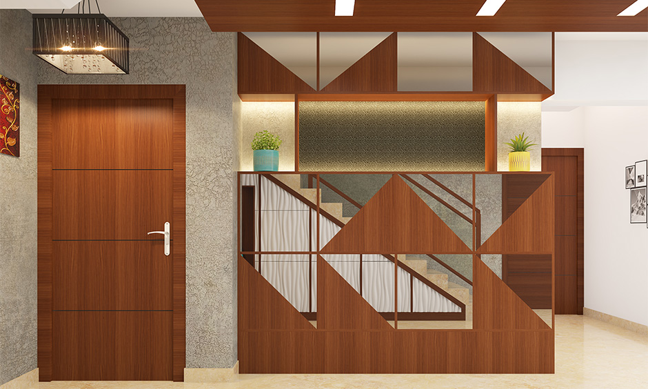 Main door veneer design in elegant matte-finished medium-brown wood with decorative chandelier