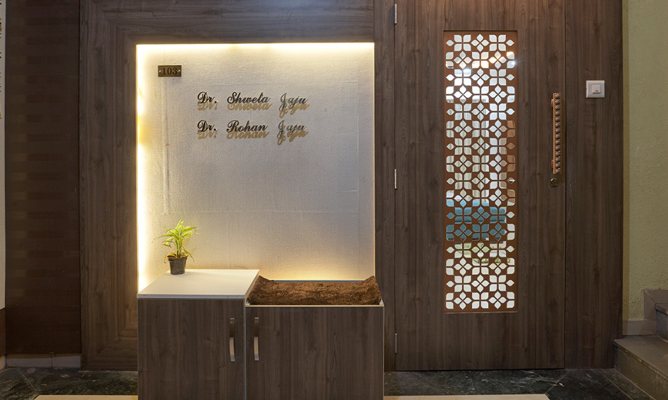 Carved, wooden main door handles showcase craftsmanship and modern design, elevating the entrance