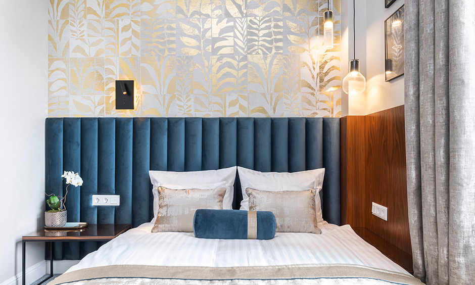 Textured off-white and gold wallpaper adds subtle glamour and depth to living room walls